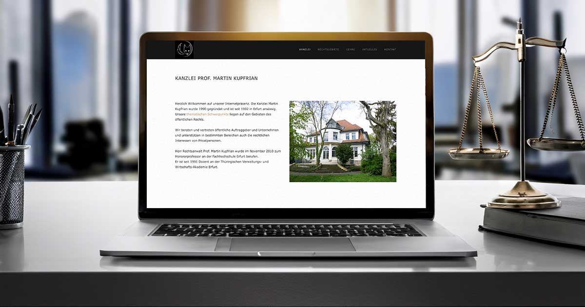 Aufgeklappter Bildschirm mit Website Kanzlei Martin Kupfrian  - Laptop steht auf dem Schreibtisch der Kanzlei